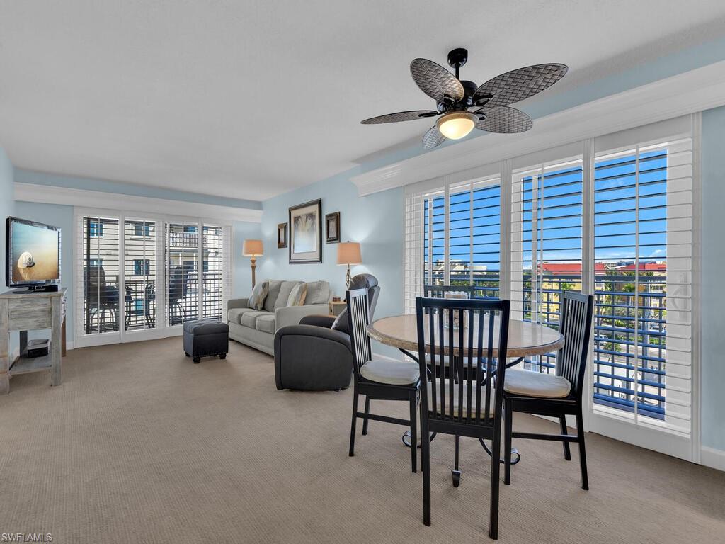Dining room with light colored carpet and ceiling fan