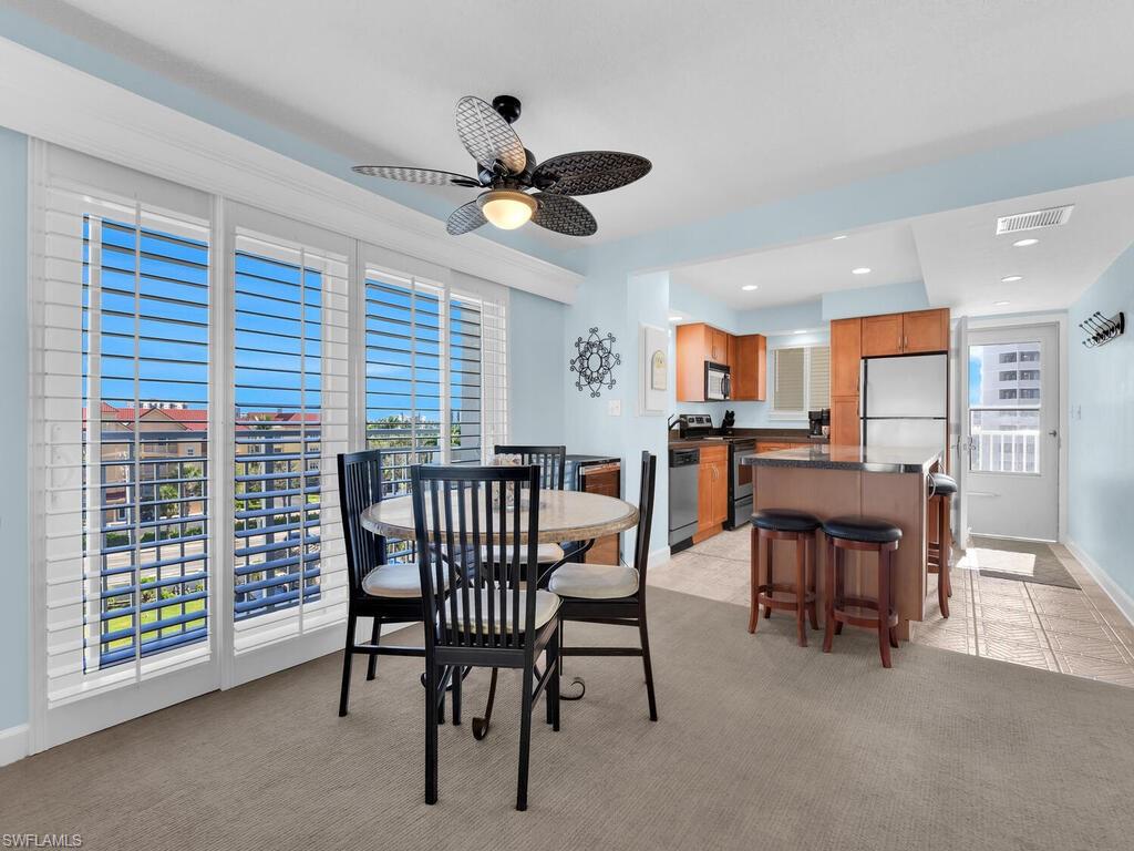 Dining space featuring light colored carpet, recessed lighting, and a ceiling fan