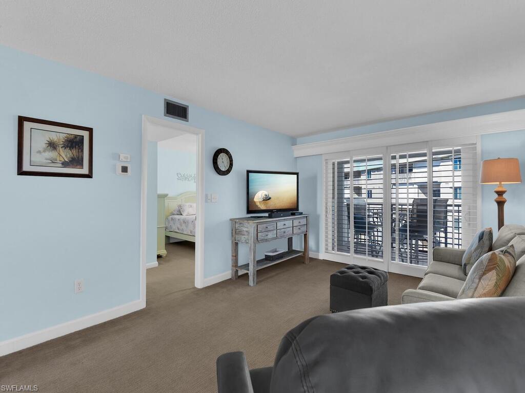 Living room with carpet flooring and baseboards