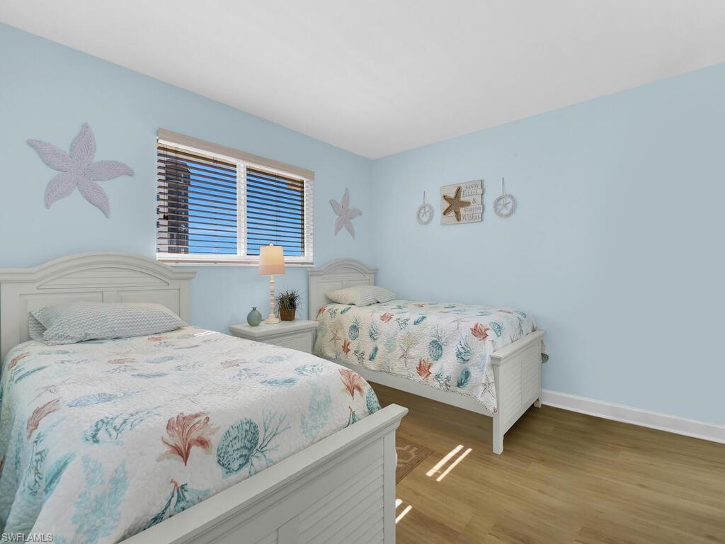 Bedroom with wood finished floors and baseboards