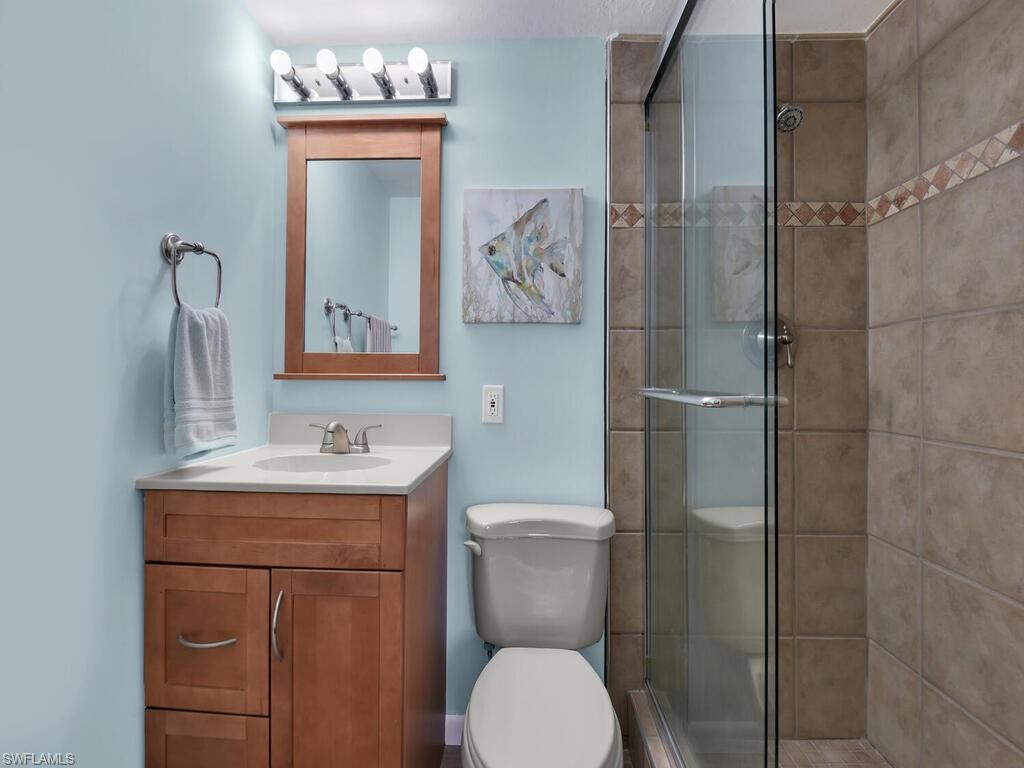 Bathroom with a stall shower and vanity