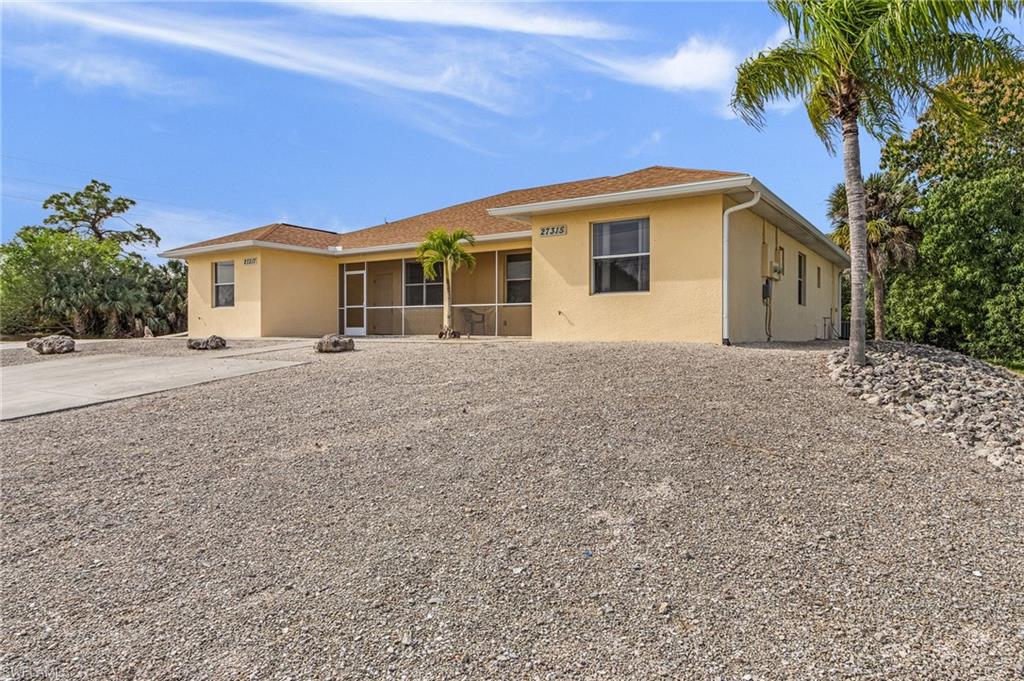 Single story home with stucco siding and a sunroom