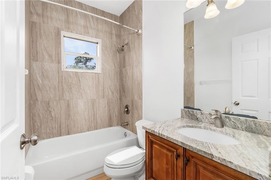 Bathroom with vanity and bathing tub / shower combination