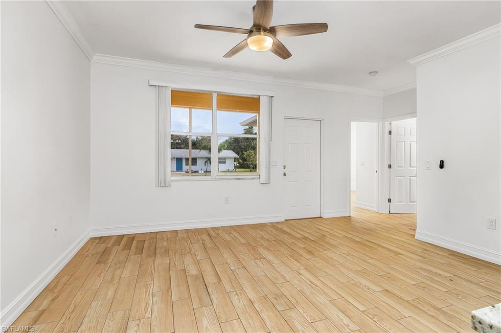Living room featuring wood-style tiled floors, and ceiling fan
