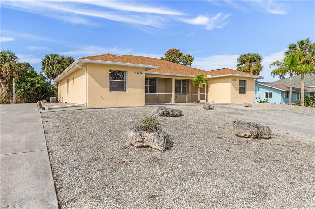 Single story home featuring stucco siding