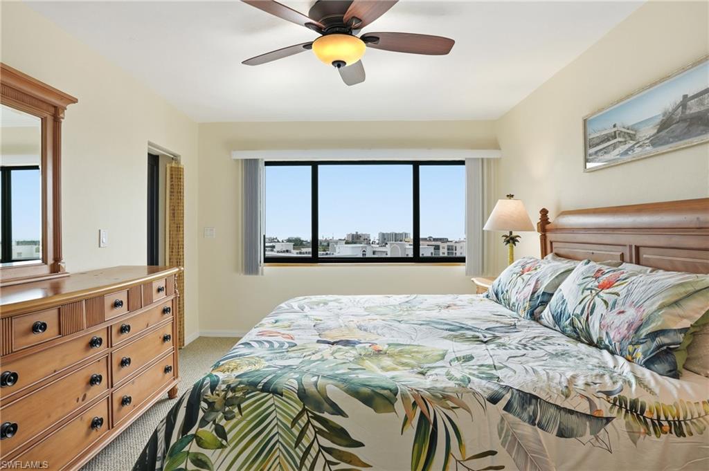 Bedroom featuring light colored carpet and a ceiling fan - Virtually Edited Image