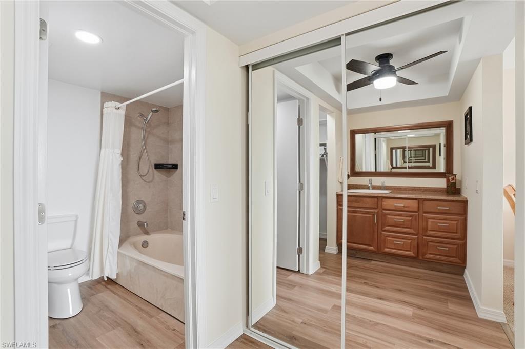 Full bath shower / tub combo, spacious vanity, and a updated ceiling fan - Virtually Edited Image