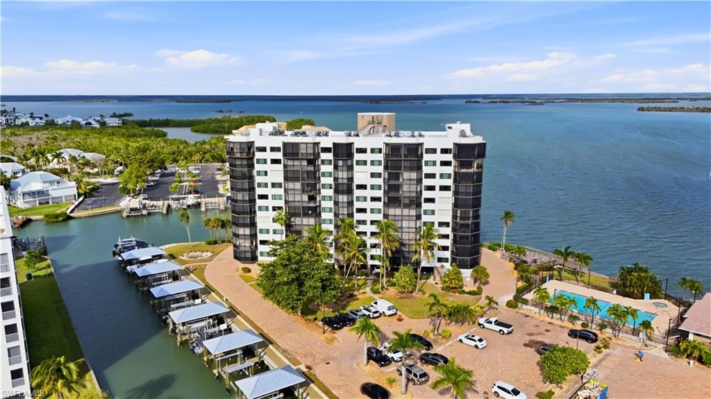Drone / aerial view of Harbour Pointe and a Estero Bay large body of water & canal with boat docks - Virtually Edited Image