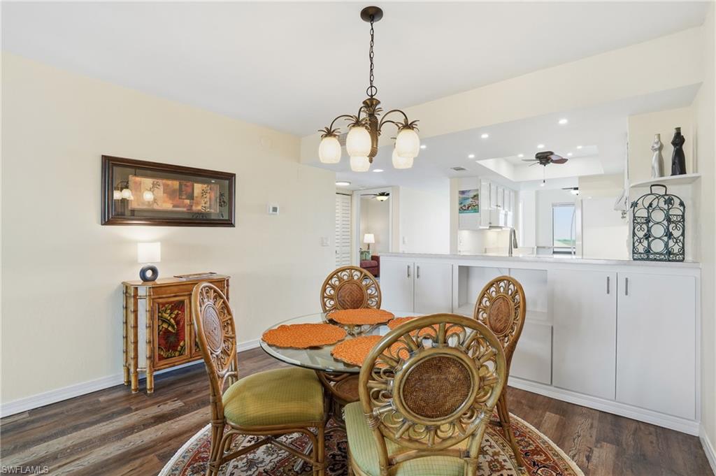 Dining area featuring a chandelier, recessed lighting, extra built in cabinets for storage  - Virtually Edited Image