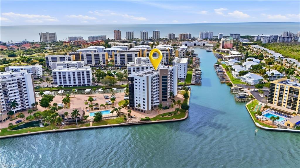 View of Harbour Pointe Condominium with Canal connecting to Estero Bay, View of Pool - Virtually Edited Image
