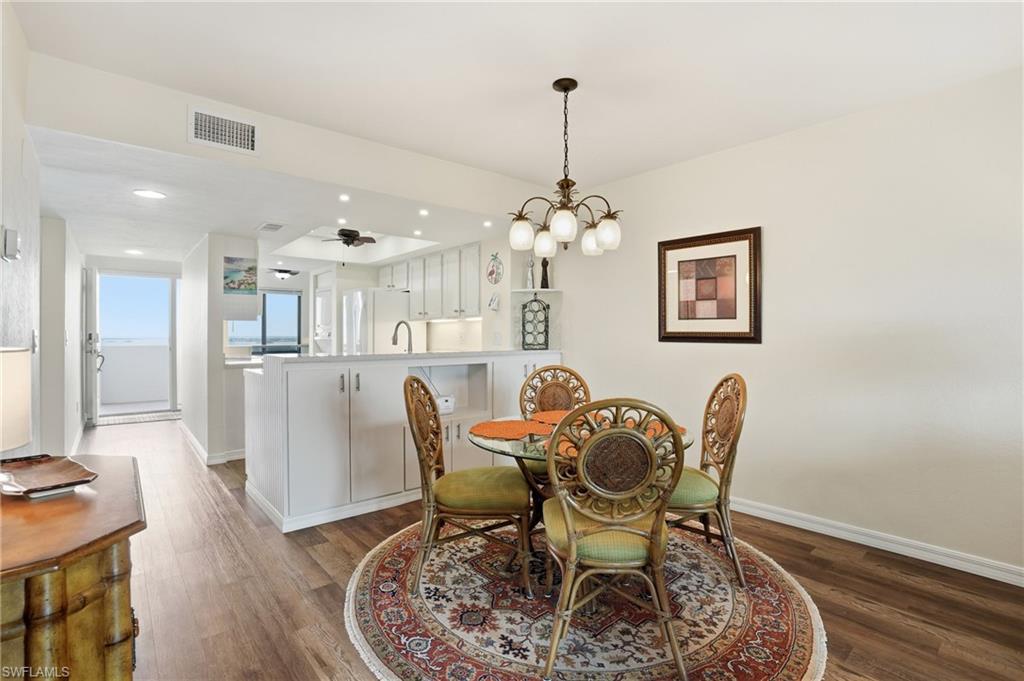 Bright and spacious diining space with a chandelier, recessed lighting - Virtually Edited Image