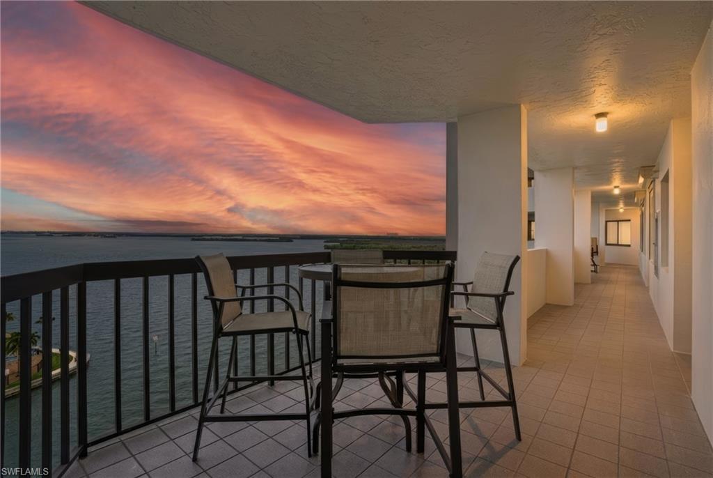 Front seating nook outside front featuring water views of Estero Bay - Virtually Edited Image