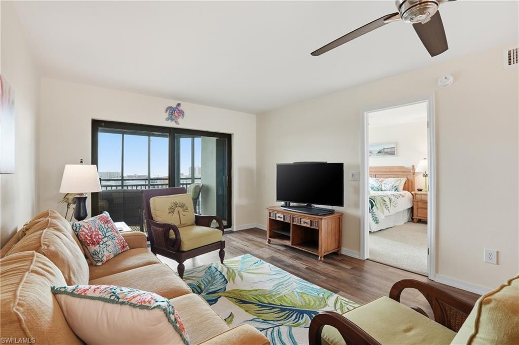 Living area with  beautiful attached patio and updated ceiling fan - Virtually Edited Image