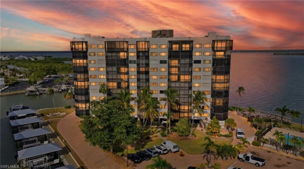 View of Harbour Pointe featuring Estero Bay at dusk- Virtually Edited Image