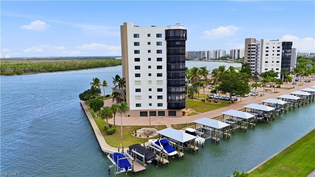 Aerial footage of Harbour Pointe with the boat docks/lifts and canal to go to Estero Bay - Virtually Edited Image
