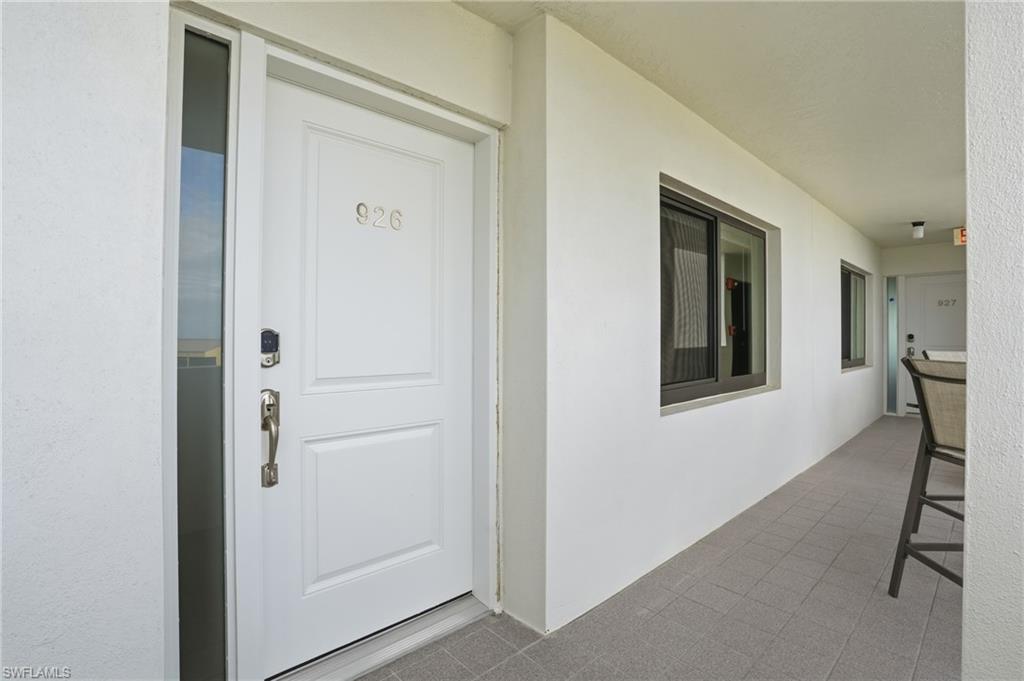 Entrance to property featuring stucco siding & new door - Virtually Edited Image