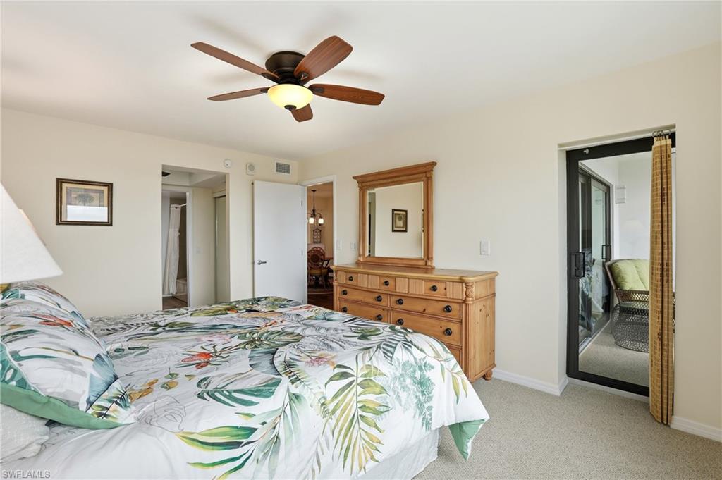 Bedroom featuring light colored carpet and a ceiling fan and patio door to outside screened in balcony - Virtually Edited Image