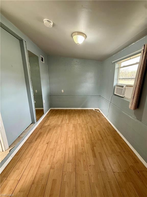 Spare room with light wood-type flooring and baseboards