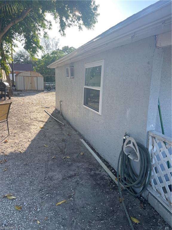 View of home's exterior featuring stucco siding and a shed