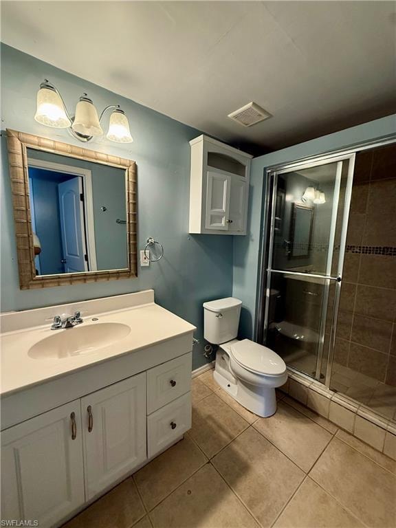 Full bathroom with vanity, a shower stall, and light tile patterned floors