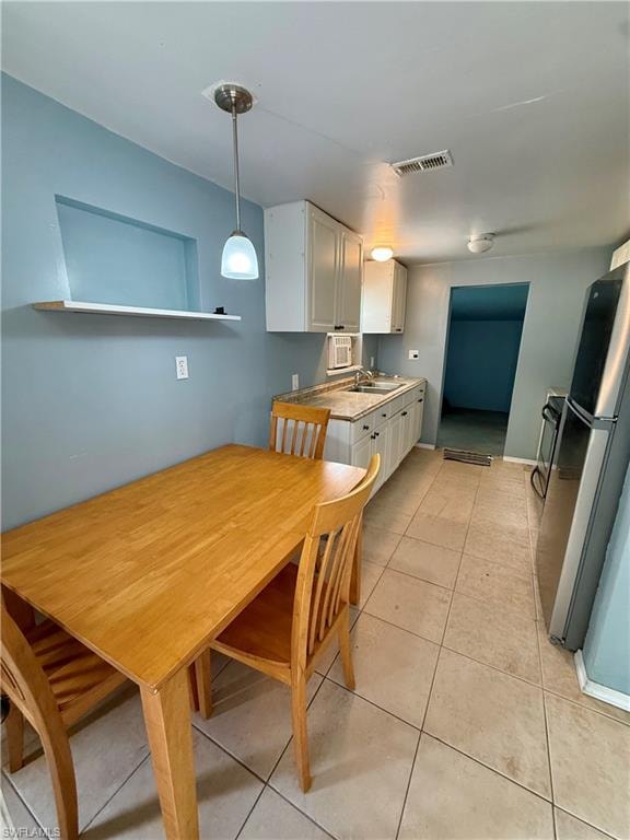 Dining space featuring light tile patterned flooring