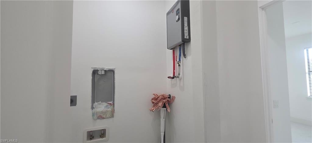 Washroom featuring water heater