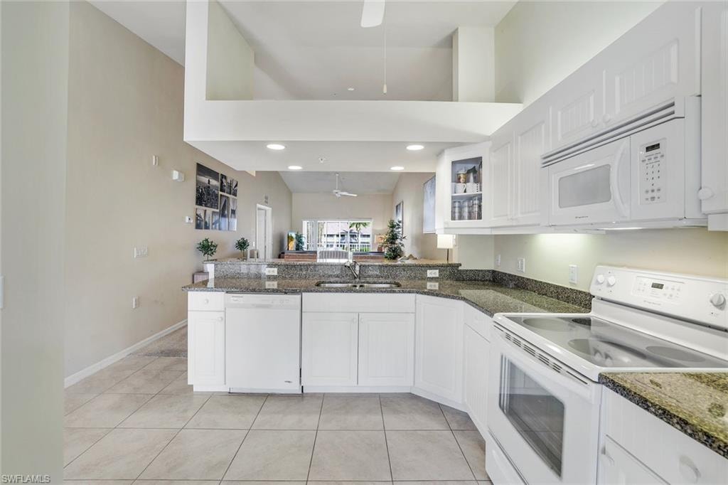 KITCHEN.BEAD BOARD WHITE CABINETS AND GRANITE COUNTERS