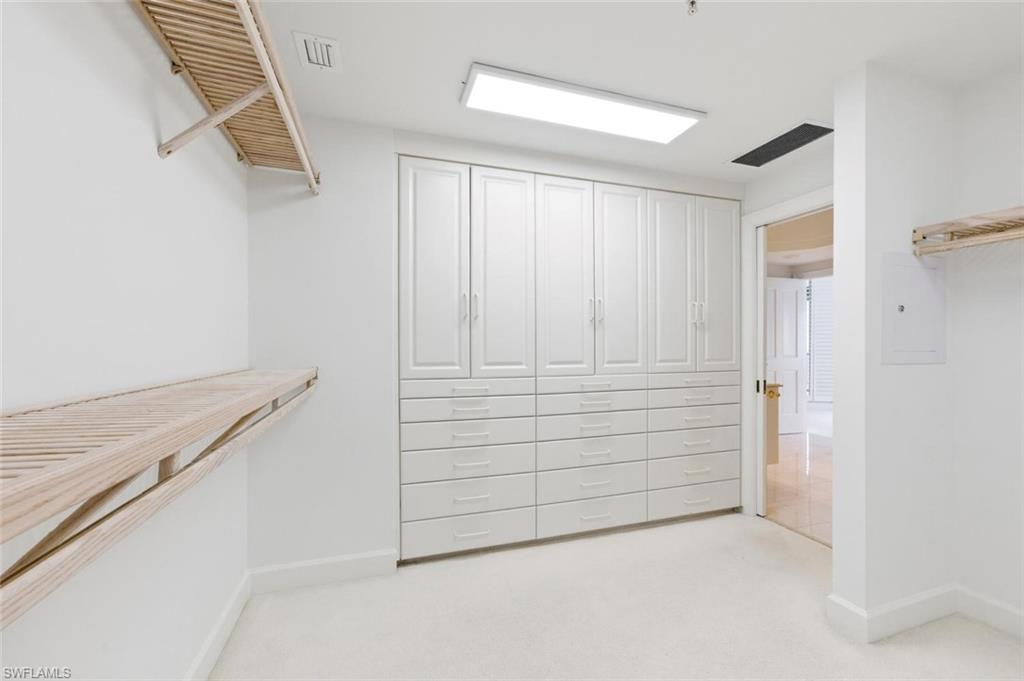 Custom built-in white cabinetry with ample drawers and upper storage