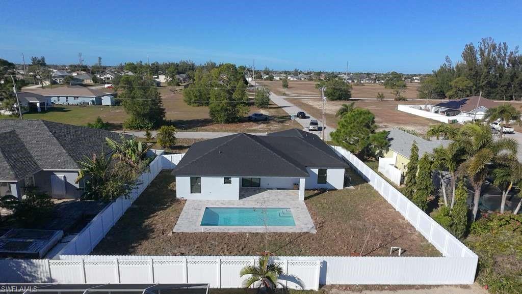 Aerial perspective of suburban area featuring a pool