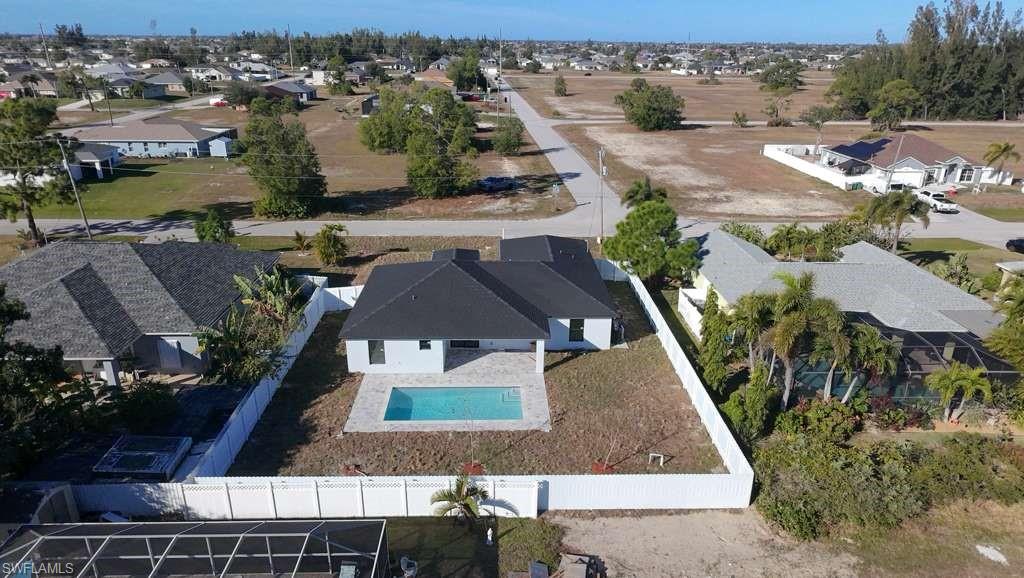 Aerial view of residential area featuring a pool