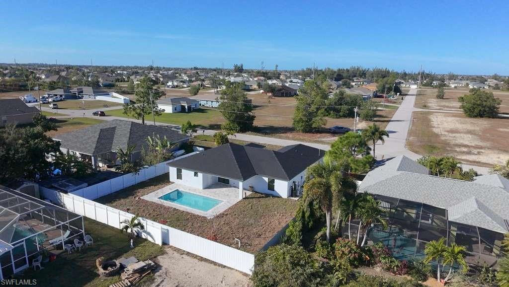 Aerial perspective of suburban area featuring a pool