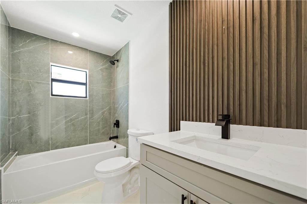 Contemporary bathroom featuring a white vanity with a white countertop, a black faucet, and a slatted wood accent wall