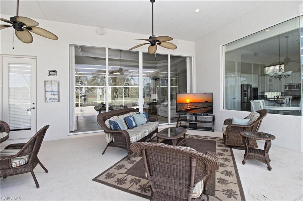 View of patio with ceiling fan and an outdoor living space