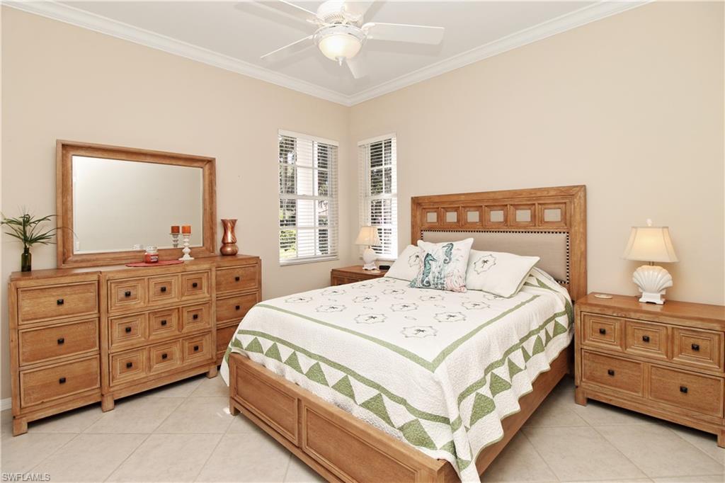 Bedroom featuring ornamental molding, ceiling fan, and light tile patterned flooring