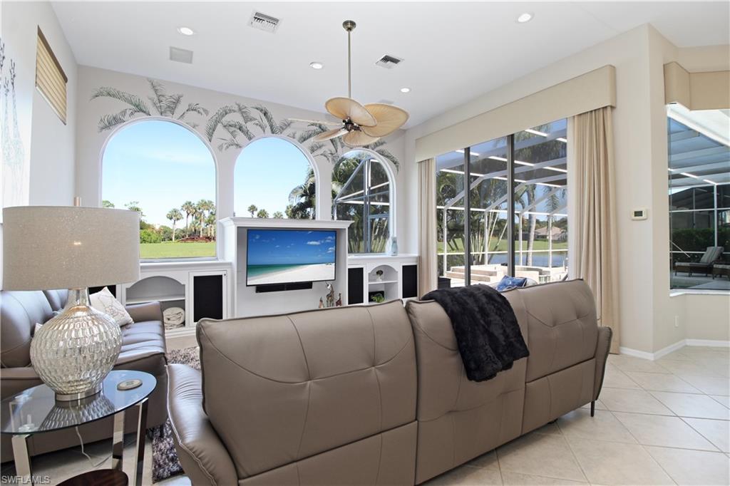 Living room with tile patterned flooring, healthy amount of natural light, recessed lighting, and ceiling fan