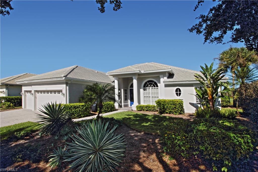 View of front of property featuring stucco siding, a garage, driveway, and a tiled roof