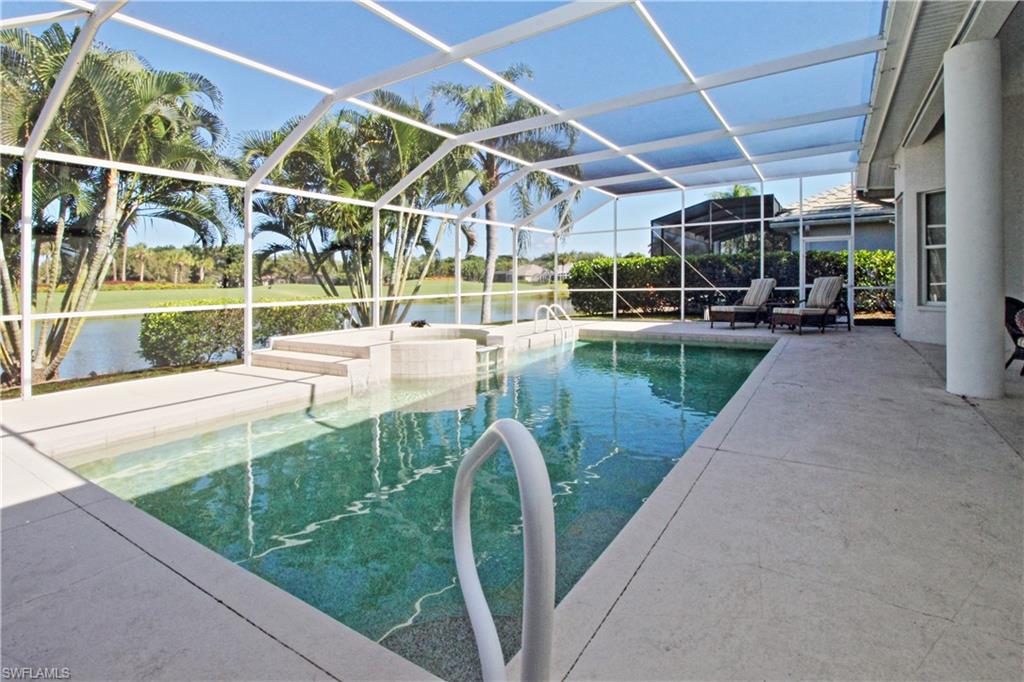 Outdoor pool featuring a sunroom, a patio area, a water view, and a lanai