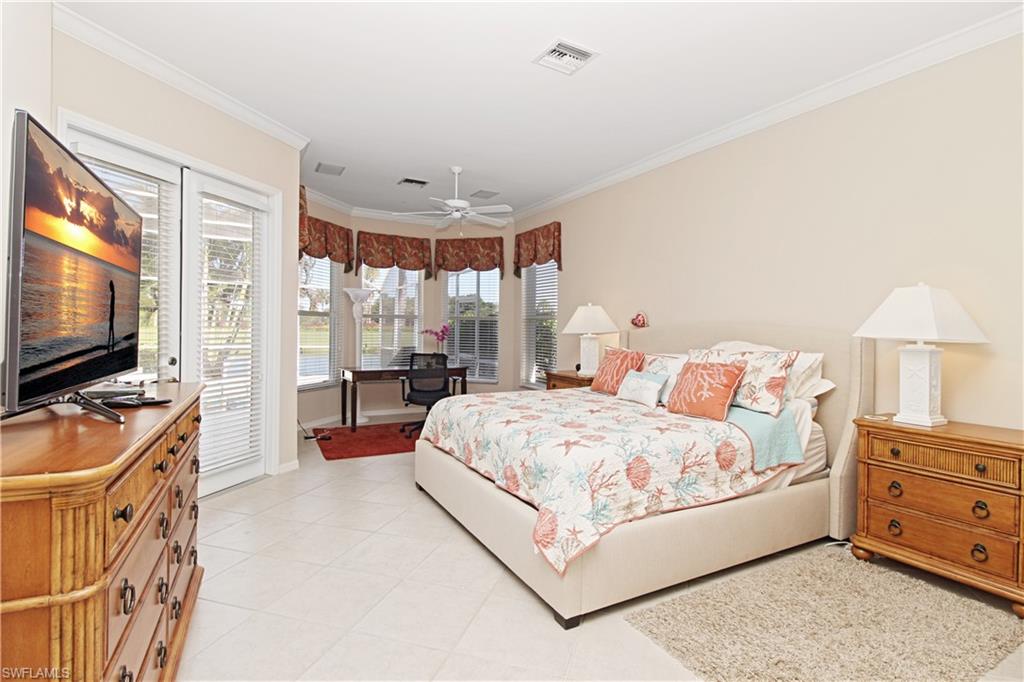 Bedroom featuring access to exterior, light tile patterned flooring, ornamental molding, and a ceiling fan
