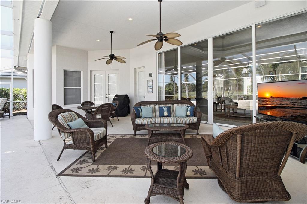 View of patio featuring ceiling fan, an outdoor living space, french doors, and a grill