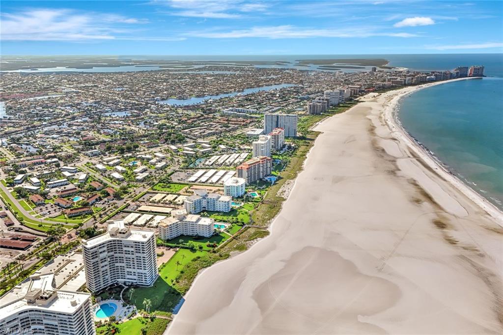View of urban area featuring waterfront with a beach