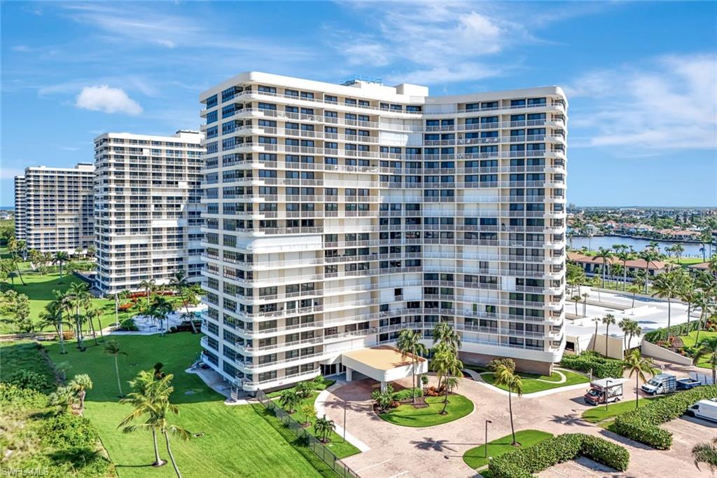 View of apartment building / complex featuring a water view