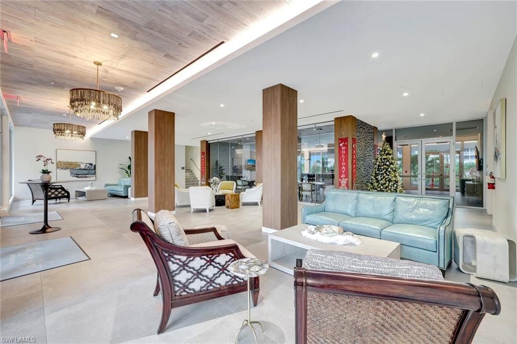 Community lobby featuring stairs, recessed lighting, and wood ceiling