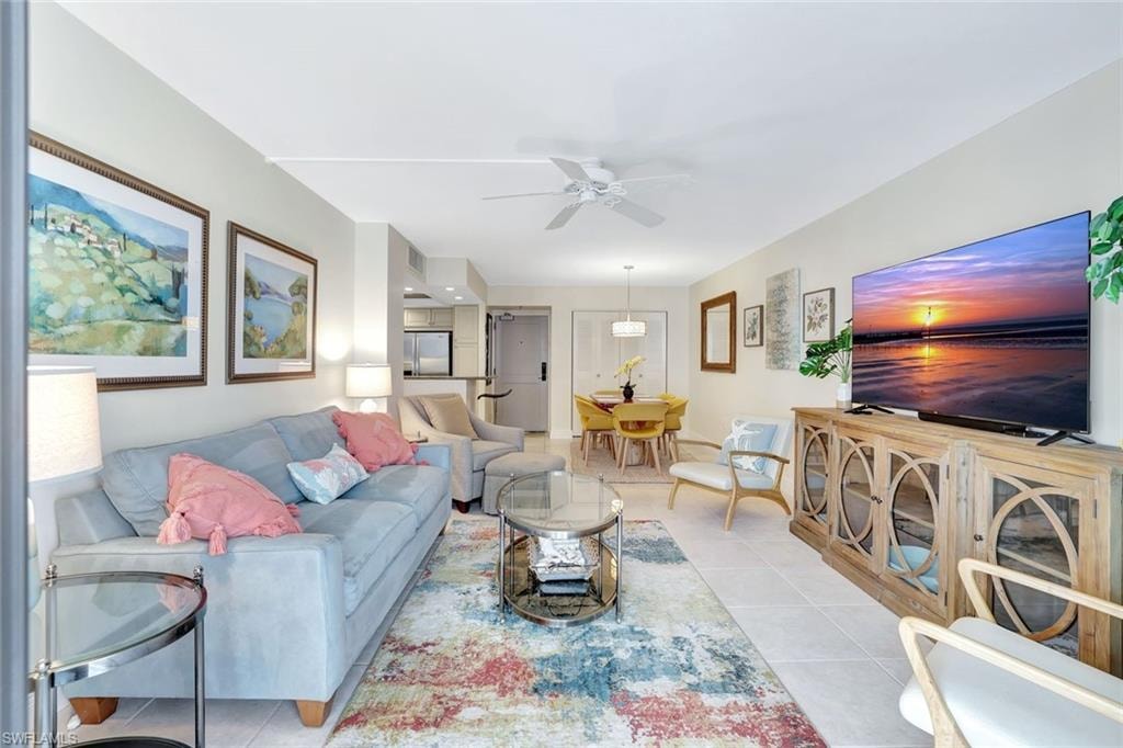 Living area with light tile patterned floors and a ceiling fan