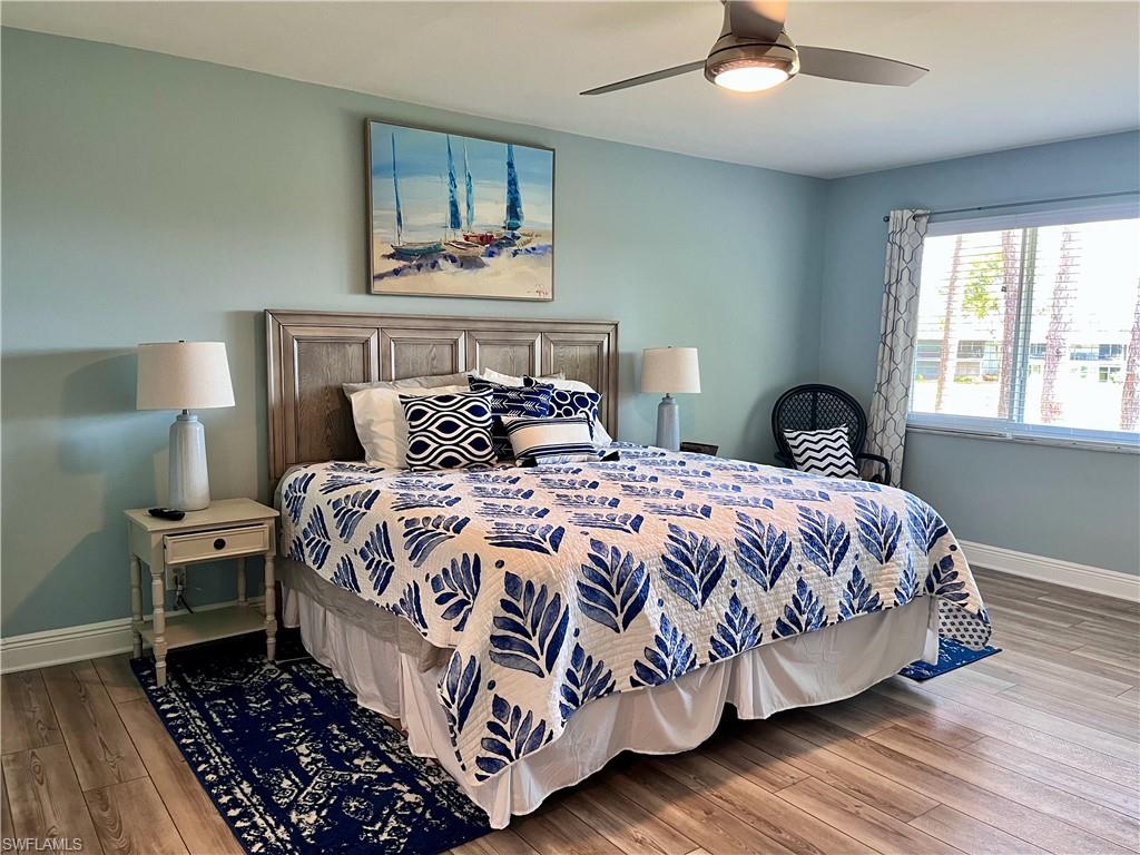 Bedroom with wood-type flooring and ceiling fan