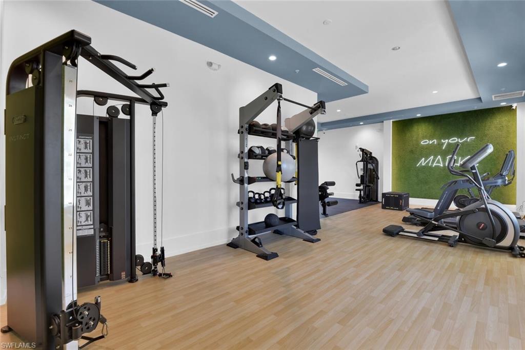Exercise room featuring hardwood / wood-style floors