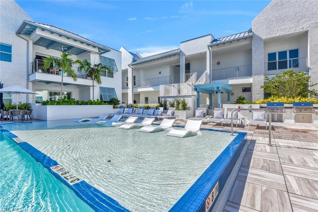 View of pool featuring grilling area and a patio area