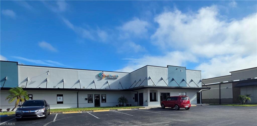 View of commercial location with uncovered parking