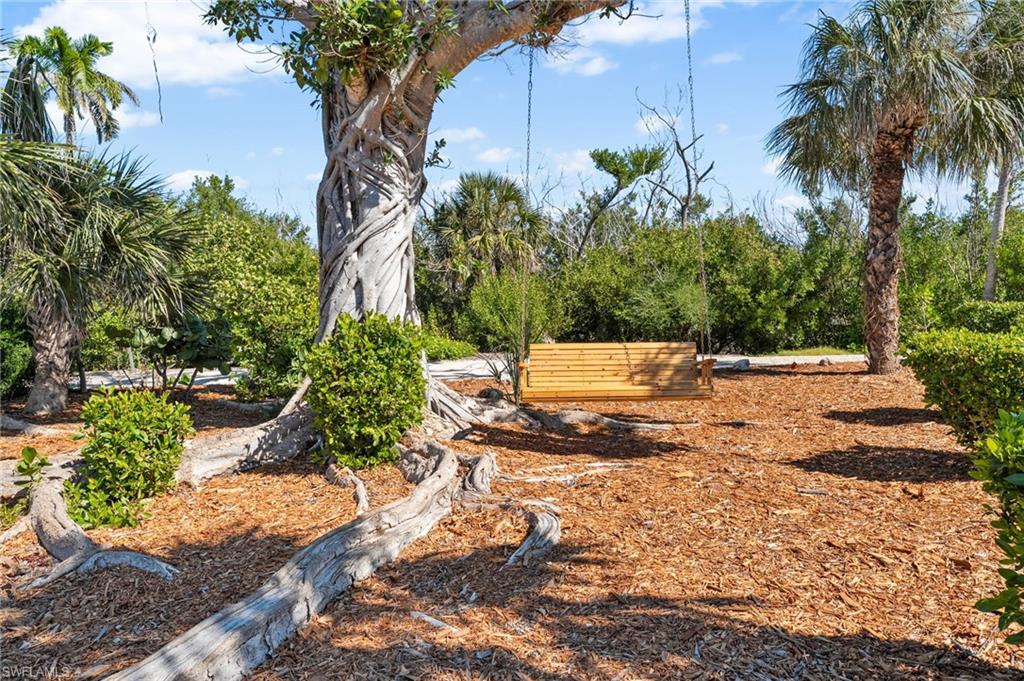 The rear of the home opens toward tranquil lake views and inviting outdoor living areas.