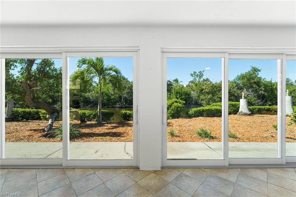 An open-concept living space filled with natural light and framed by serene water views.