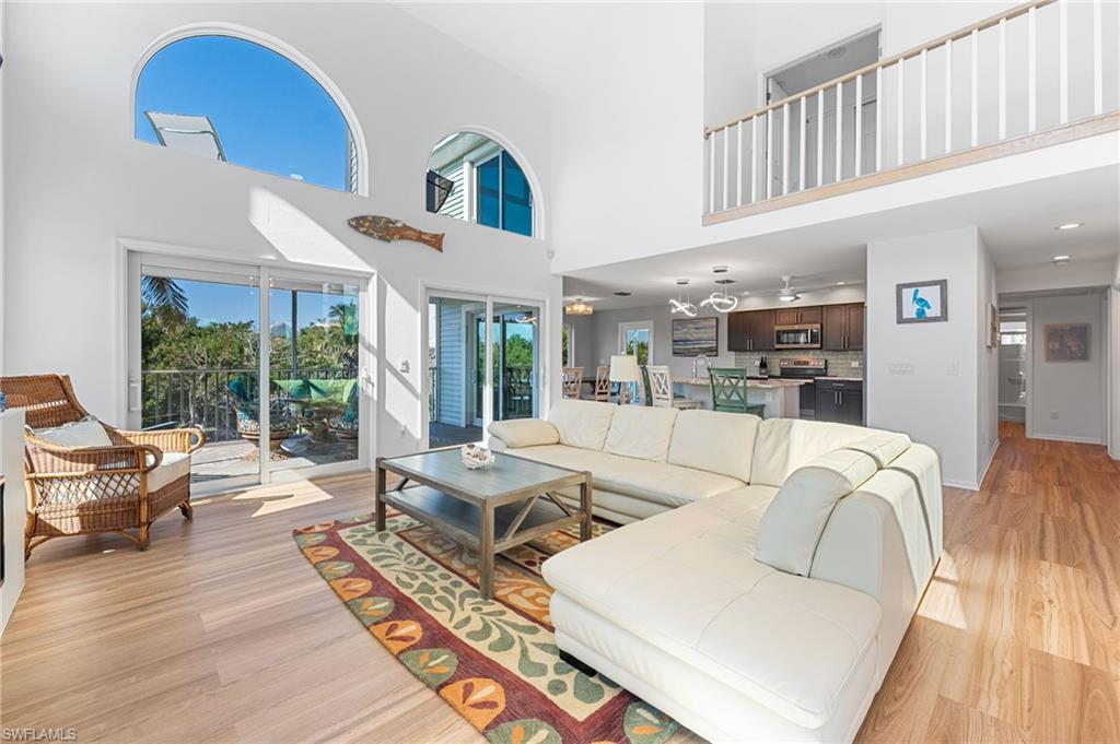 An open-concept living space filled with natural light and framed by serene water views.